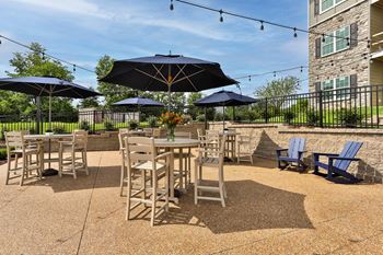 A patio with tables and chairs and umbrellas